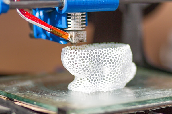 3d printer at work making or printing goods on cnc